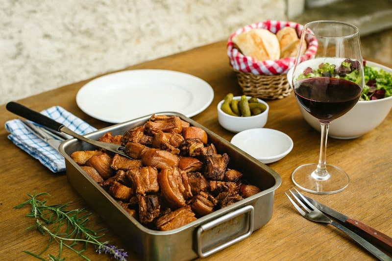 Wein zum Essen Rillons de Tours Anjou, Landhaustisch mit Rosé und Baguette