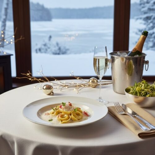 Wein zum Essen: Hummer-Tortellini in Champagnerrahm serviert mit einem Glas Champagner.